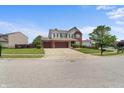 Charming two story home featuring a well maintained lawn and long driveway at 10312 Gladeview Dr, Indianapolis, IN 46239