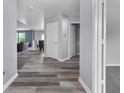 An airy hallway with hard surface floors and a view into the dining room at 10312 Gladeview Dr, Indianapolis, IN 46239