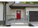 Welcoming front porch and bright red front door and painted trim at 10398 Ethel St, Carmel, IN 46280