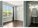 Bedroom with a large window and attached bathroom with a pedestal sink at 10606 Glenwyck Pl, Noblesville, IN 46060