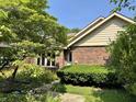 Charming brick home with a well-maintained front yard and inviting entrance at 10712 Downing St, Carmel, IN 46033