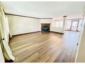 Bright living room featuring new floors, a cozy fireplace, and ample natural light at 10900 Clear Spring Dr, Camby, IN 46113