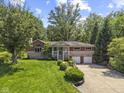 Charming two-story home with a lush green lawn and manicured landscaping at 11603 Maze Rd, Indianapolis, IN 46259