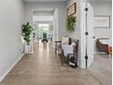 Inviting foyer featuring wood floors, decorative accents, and seamless transition to the dining area at 11809 Redpoll Trl, Noblesville, IN 46060
