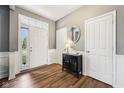 Inviting foyer with hardwood floors, neutral paint, and classic wainscoting detail at 123 Bentree Blvd, Danville, IN 46122
