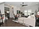 Bright living room featuring modern ceiling fan, hardwood floors, and stylish decor at 13616 Whitten N Dr, Fishers, IN 46037