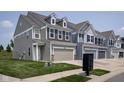 A row of homes featuring a two-car garage and manicured lawns at 14110 Bay Willow Dr, Fishers, IN 46037