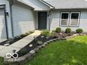 Close-up of the front entryway showcasing landscaping and a walkway at 14255 Holly Berry Cir, Fishers, IN 46038