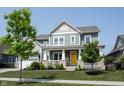 Inviting two-story home boasts a covered porch and a well-maintained front yard at 14982 Dawnhaven Dr, Westfield, IN 46074