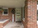 A welcoming brick front porch showcasing decorative accents and a cheerful atmosphere at 1504 Mcclure Rd, Columbus, IN 47201