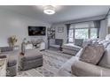 Comfortable living room features plush gray seating, a large window, and modern decor at 1504 Mcclure Rd, Columbus, IN 47201