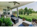Spacious, covered patio with comfortable seating and a serene view of the lush backyard at 15879 Viking Commander Way, Westfield, IN 46074