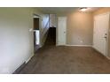 View of the interior showcasing staircase and multiple doorways and neutral colored walls at 1749 N Graham Ave, Indianapolis, IN 46218