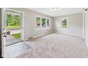 Bright living room featuring neutral carpet and large windows for natural light at 220 Central Ave, Anderson, IN 46012