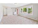 Inviting living room with neutral walls, plush carpet, and great natural light at 220 Central Ave, Anderson, IN 46012