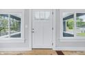 Bright white front door framed by large windows, interior view showcasing its welcoming ambiance at 2896 Sutherland Ave, Indianapolis, IN 46205