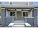 Inviting front porch with gray brick pillars, fresh paint, and a neatly displayed house number above the front door at 2896 Sutherland Ave, Indianapolis, IN 46205