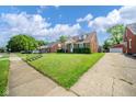 Lovely brick home featuring a tidy lawn, a driveway, and an inviting curb appeal at 2908 Sherman St, Anderson, IN 46016