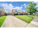 Beautiful brick home featuring a spacious driveway and a well-maintained lawn at 2908 Sherman St, Anderson, IN 46016