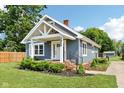 Charming home showcasing architectural details, fresh landscaping, and inviting front porch at 2928 Mounds Rd, Anderson, IN 46016