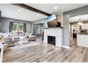 Open living room boasts a decorative fireplace, wood floors, and comfortable seating area at 2928 Mounds Rd, Anderson, IN 46016