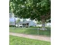 Quaint home featuring a fenced yard and mature trees offering shade and privacy at 3101 Danbury Rd, Indianapolis, IN 46222