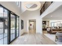Bright foyer with soaring ceilings, hardwood floors, and grand chandelier, leading into open-concept living space at 3549 W 131St St, Carmel, IN 46032
