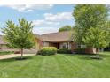 Beautiful brick home with well-maintained lawn and landscaping, including mature trees at 3571 S Cedar Creek Ln, New Palestine, IN 46163