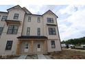 A modern two-story townhome boasts a stylish exterior with a combination of siding and brick accents at 4141 Barrel Ln, Westfield, IN 46062