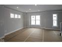 Spacious living room featuring large windows providing ample natural light and newly installed flooring at 4141 Barrel Ln, Westfield, IN 46062