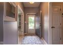 Welcoming hallway with light gray walls and flooring, leading into the home's interior spaces at 4353 W Parkway Ct, New Palestine, IN 46163