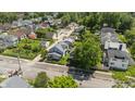 Aerial view of a charming home in a residential neighborhood with mature trees at 4709 E New York St, Indianapolis, IN 46201