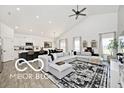 Open-concept living room boasts a large sectional sofa and vaulted ceilings at 4726 Amber Wood Ln, Indianapolis, IN 46235