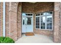 Inviting brick entryway with a white front door and sidelight window at 4810 Crystal River Ct, Indianapolis, IN 46240