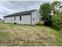 View of the rear exterior of the house with a wooden deck at 5 Watson Dr, Trafalgar, IN 46181