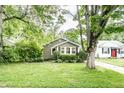 Street view of cozy home with a lush front yard and mature shade trees at 5119 Norwaldo Ave, Indianapolis, IN 46205