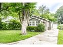 View of home with a concrete driveway and a detached garage to the rear at 5119 Norwaldo Ave, Indianapolis, IN 46205