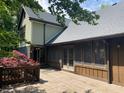 Exterior view of the home showcasing a wooden deck, screened in porch area, and yard at 5530 Shawnee Trail South Dr, Indianapolis, IN 46220