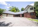 Spacious home with a long driveway, brick and siding exterior, and attached two car garage at 5530 Shawnee Trail South Dr, Indianapolis, IN 46220