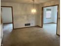 Dining room featuring neutral walls, vintage lighting, and easy access to adjacent rooms at 5632 Spring Mist Cir, Indianapolis, IN 46237