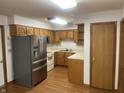 Functional kitchen featuring oak cabinets, stainless steel refrigerator, and plenty of counter space at 5632 Spring Mist Cir, Indianapolis, IN 46237