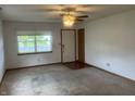 Bright living room with a ceiling fan, neutral walls, and large window offering ample natural light at 5632 Spring Mist Cir, Indianapolis, IN 46237