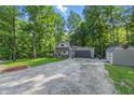 Charming home nestled amongst lush trees, featuring an attached garage and a well-maintained lawn at 5824 Wesley Rdg, Martinsville, IN 46151