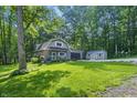Charming home nestled amongst lush trees, featuring an attached garage and a well-maintained lawn at 5824 Wesley Rdg, Martinsville, IN 46151