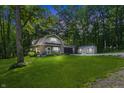 Charming home nestled amongst lush trees, featuring an attached garage and a well-maintained lawn at 5824 Wesley Rdg, Martinsville, IN 46151