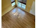 Bright living room featuring laminate flooring and two large windows at 5850 Pennekamp Dr, Plainfield, IN 46168