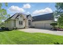Elegant brick home with a manicured lawn, two-car garage, and beautiful landscaping at 5940 Chapmans Trl, Carmel, IN 46033