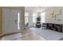 Inviting living room with abundant natural light, modern decor, and elegant chandelier at 6107 Flagler Ln, Brownsburg, IN 46112