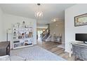 Open-concept living area featuring hardwood floors, stylish shelving, and views into other living spaces at 6107 Flagler Ln, Brownsburg, IN 46112