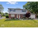 Charming two-story home with brick and vinyl exterior, landscaped yard, and inviting front entrance at 6133 Buttonwood Dr, Noblesville, IN 46062